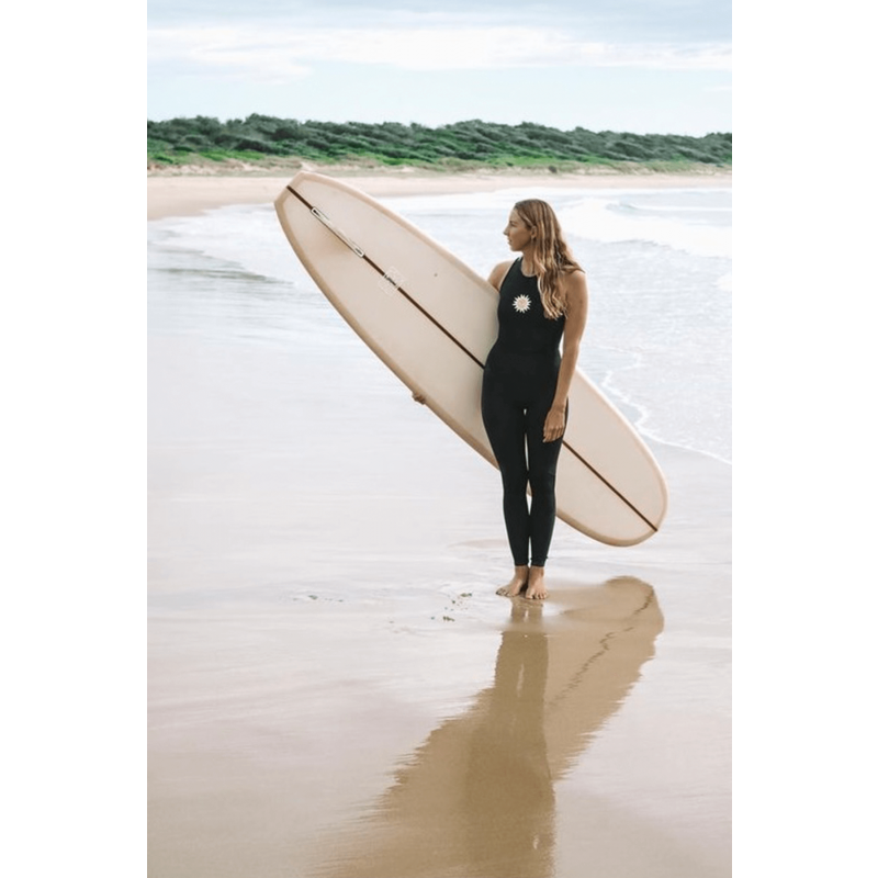 Inner Relm Happyheart Long Jane on model with surfboard