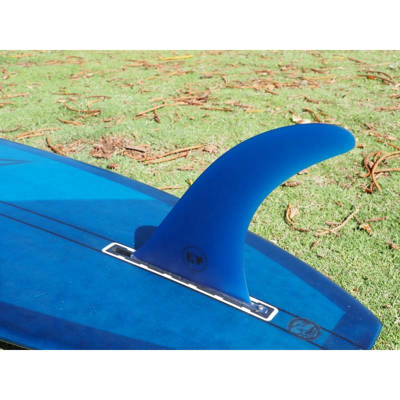 LV Fins LB Classic Raked 10" Single Fin - Translucent Blue on lonboard on the grass