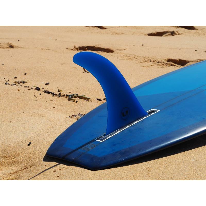 LV Fins LB Classic Raked 10" Single Fin - Translucent Blue on lonboard on the sand