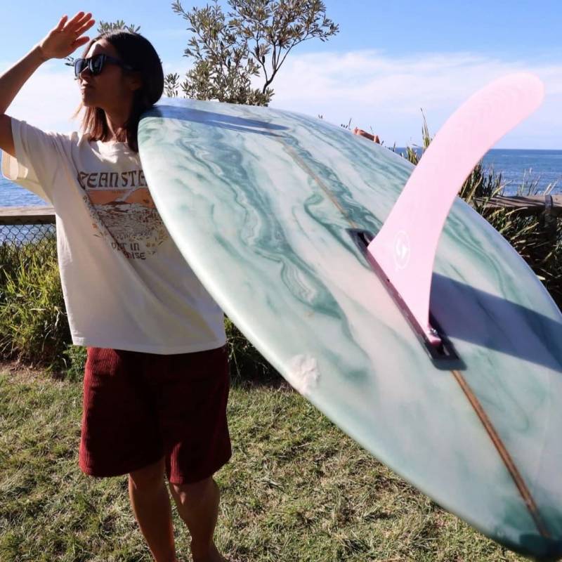 LVfins LB Classic Raked Single Fin - Pink on board at the beach