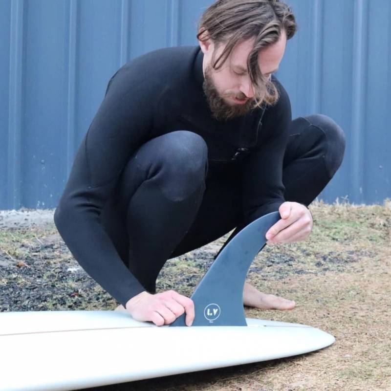 LVfins LB Classic Raked Single Fin - Navy getting installed on a longboard surfboard