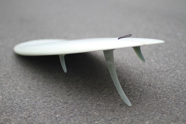 surfboard tail showing 2 + 1 fin setup