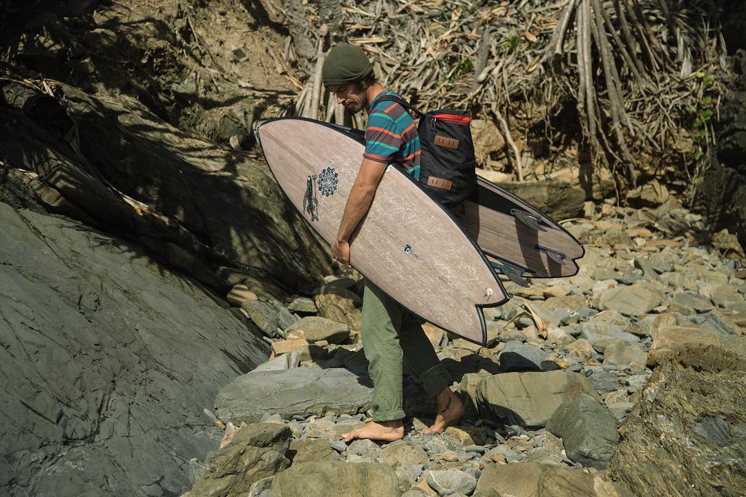 Dave Rastovich holding a Flax Surfboard eco board by Gary Ncneill